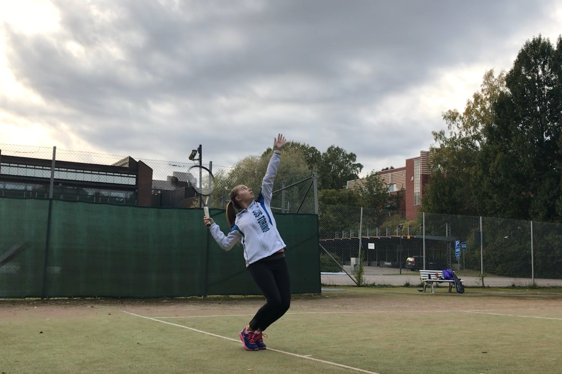 Elena practicing her serve